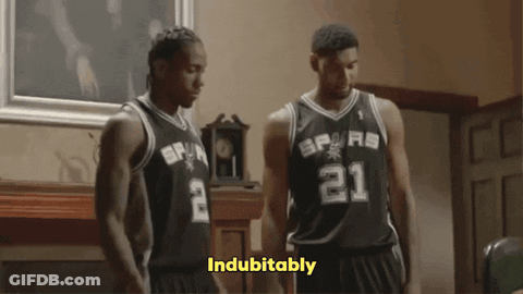 Two Basketball Players Wearing Spurs Jerseys Stand In A Room GIF