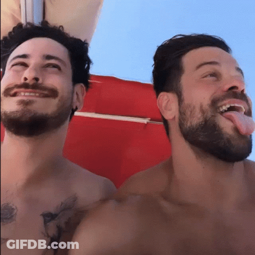 Two Bearded Men, One Sticking Tongue Out GIF