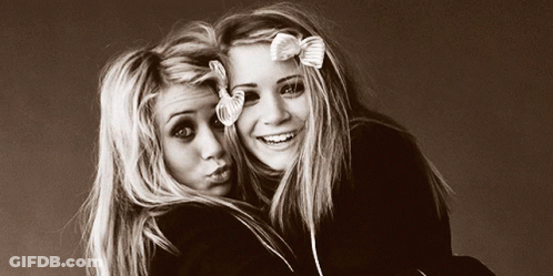 Two Blonde Girls With Bows Posing GIF