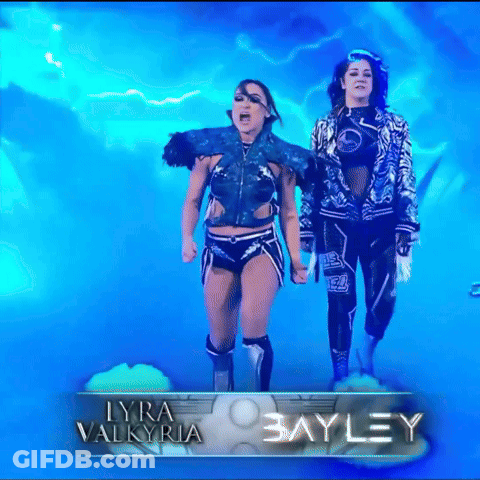 Two Blue-Haired Women Walking Red Carpet Past The Next Thing Sign GIF