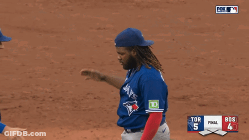 Two Blue Jays Players Shake Hands During A Baseball Game GIF