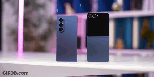 Two Blue Phones Are Sitting On A Table With A Pink Light In The Background GIF