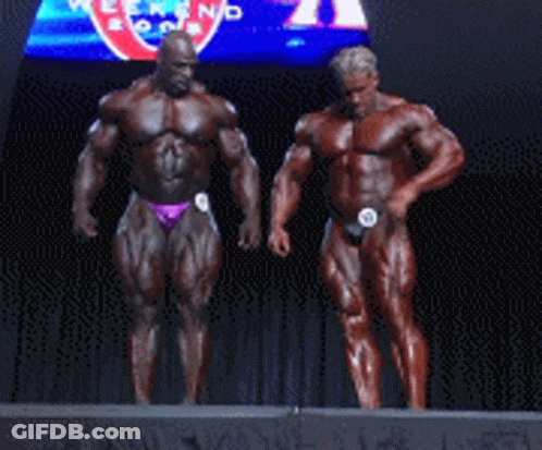 Two Bodybuilders On Stage In Front Of Pepsi Sign GIF