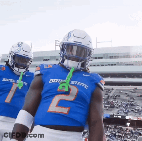Two Boise State Football Players Wearing Blue Jerseys GIF
