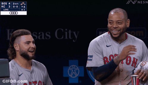 Two Boston Red Sox Players Are Laughing During A Game GIF