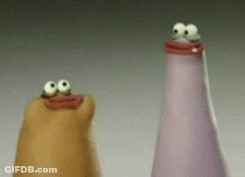 Two Bottles With Googly Eyes Are Sitting Next To Each Other On A Table . GIF
