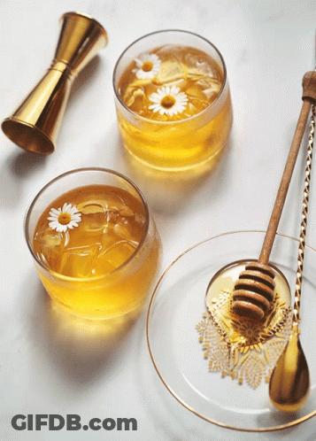 Two Bowls Of Honey With Daisies And Honey Dipper GIF