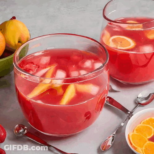 Two Bowls Of Punch With Spoons And Fruit Bowl GIF