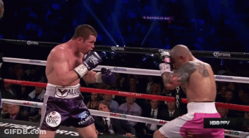 Two Boxers Are Fighting In A Boxing Ring And One Of Them Is Wearing Purple Shorts That Say Value GIF