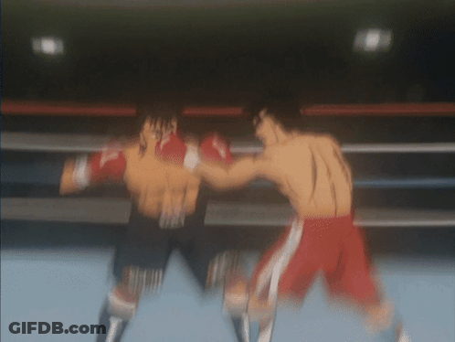 Two Boxers Are Fighting In A Boxing Ring And One Of Them Is Wearing Red Shorts GIF