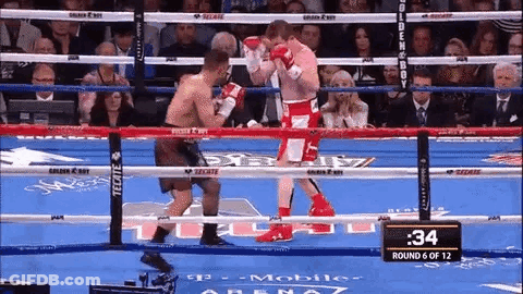 Two Boxers Are Fighting In A Boxing Ring And The Time Is 34 Seconds . GIF