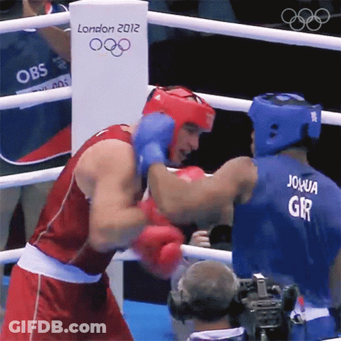 Two Boxers Are Fighting In A Boxing Ring With A London 2012 Sign In The Background GIF