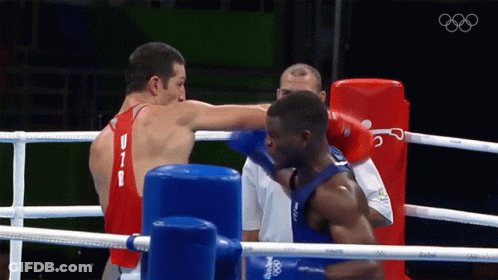 Two Boxers Are Fighting In A Ring And One Has The Letter B On His Shirt GIF