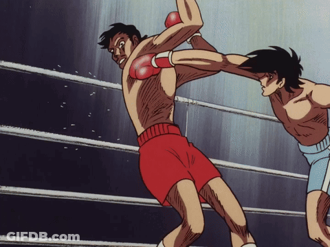 Two Boxers Are Fighting In A Ring And One Is Wearing Red Gloves GIF