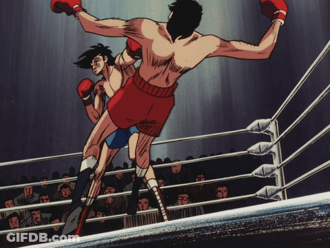 Two Boxers Are Fighting In A Ring With A Crowd In The Background GIF