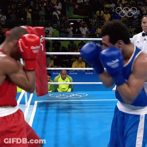 Two Boxers Are Fighting In A Ring With A Sign That Says Rio2016 GIF
