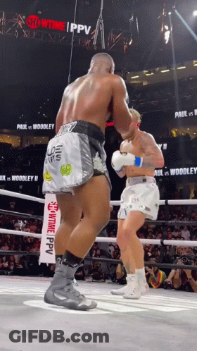 Two Boxers Are Fighting In A Ring With A Sign That Says Showtime Ppv GIF