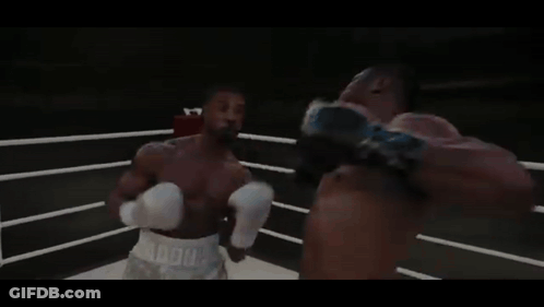 Two Boxers Are Fighting In A Ring With A Sign That Says World Heavyweight Champions On It GIF