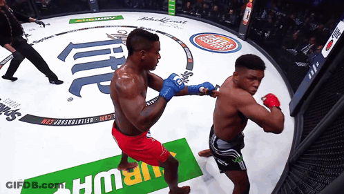 Two Boxers Are Fighting In A Ring With A Subway Ad GIF