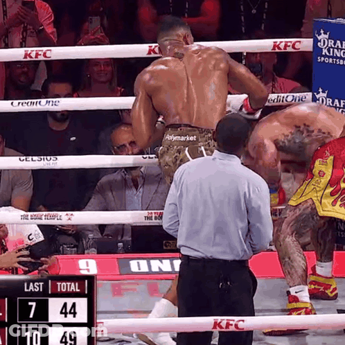 Two Boxers Are In A Ring With A Scoreboard That Says Last Total 7 44 10 49 GIF