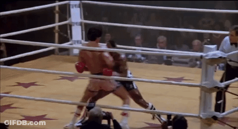 Two Boxers Fighting In Boxing Ring With Referee GIF