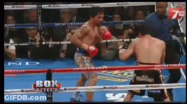 Two Boxers Fighting In Ring With Box On Ropes GIF