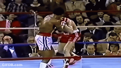 Two Boxers Fighting In Ring With Letter T GIF