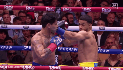 Two Boxers Fighting In Ring With Ring On Ropes GIF