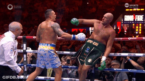 Two Boxers Fighting, One Wearing 'Npsy-King' Shorts GIF