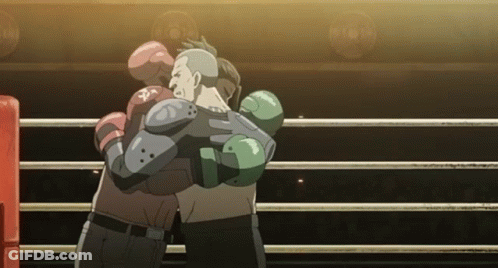 Two Boxers Hugging In A Boxing Ring With One Wearing A Glove That Says ' Pa ' On It GIF