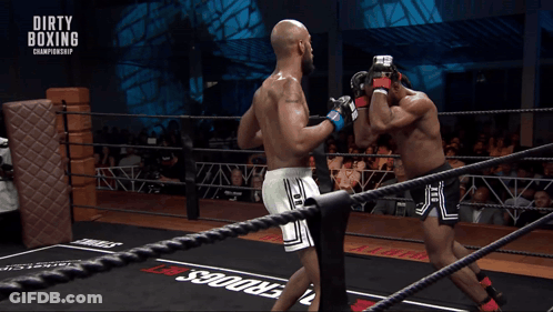Two Boxers In A Boxing Ring With Dirty Boxing Championship Written On The Ropes GIF