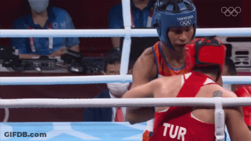 Two Boxers In A Ring One Of Whom Is Wearing A Tur Jersey GIF