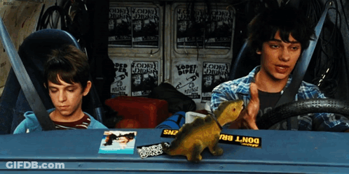 Two Boys Are Sitting In A Car With A Yellow Sticker That Says Do N't Bru GIF