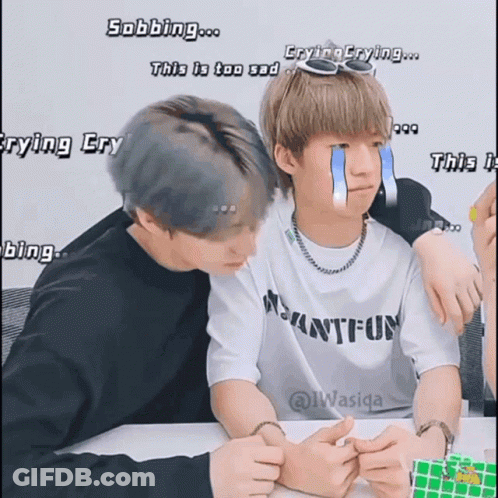 Two Boys Are Sitting Next To Each Other And One Has A Tear Coming Out Of His Eye GIF