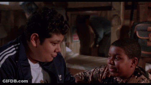 Two Boys Are Sitting Next To Each Other With The Words This Pleases Me Behind Them GIF