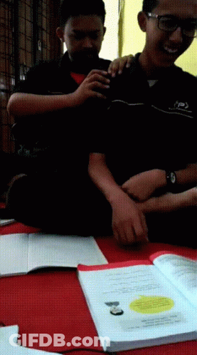 Two Boys Are Sitting On The Floor With One Wearing A Shirt That Says ' Jsp ' On It GIF