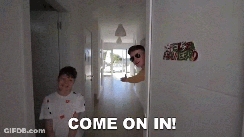 Two Boys Are Standing In A Hallway And One Of Them Says Come On In GIF