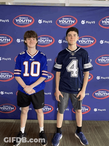 Two Boys Are Standing In Front Of A Wall That Says Playvs Youth GIF