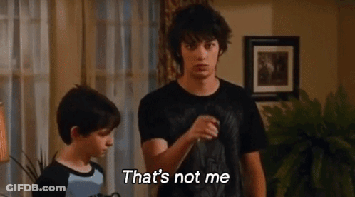 Two Boys Are Standing Next To Each Other In A Living Room And One Of Them Is Saying That 'S Not Me . GIF