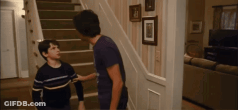 Two Boys Are Standing On A Set Of Stairs And One Of Them Is Wearing A Striped Shirt GIF