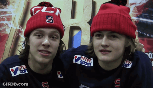 Two Boys In Red Beanies With Letters S And U GIF