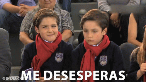 Two Boys In Scarves Sitting In Crowd Saying Me Desesperanzas GIF