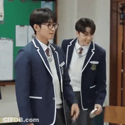 Two Boys In School Uniforms Standing Next To Each Other GIF