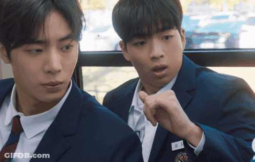 Two Boys In Suits And Ties Are Sitting Next To Each Other With One Wearing A Name Tag That Says ' A ' GIF