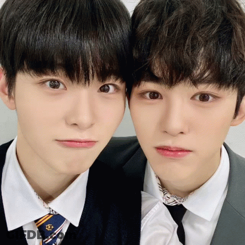 Two Boys In Suits And Ties Posing GIF