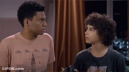 Two Boys Looking At Each Other One In Far Out Shirt GIF
