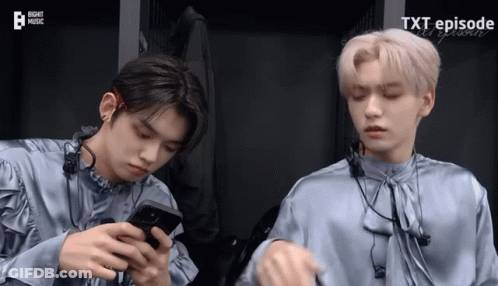 Two Boys Looking At Phones Saying Xt Episode GIF