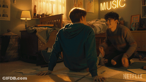Two Boys Sit On The Floor In A Bedroom With A Music Sign Above Them GIF