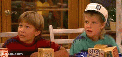 Two Boys Sitting At Table With Food And Drinks GIF