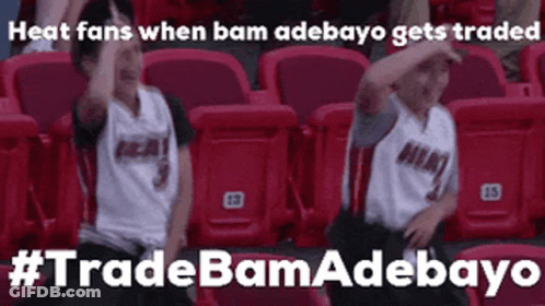 Two Boys Sitting With Arms Up In Stadium GIF